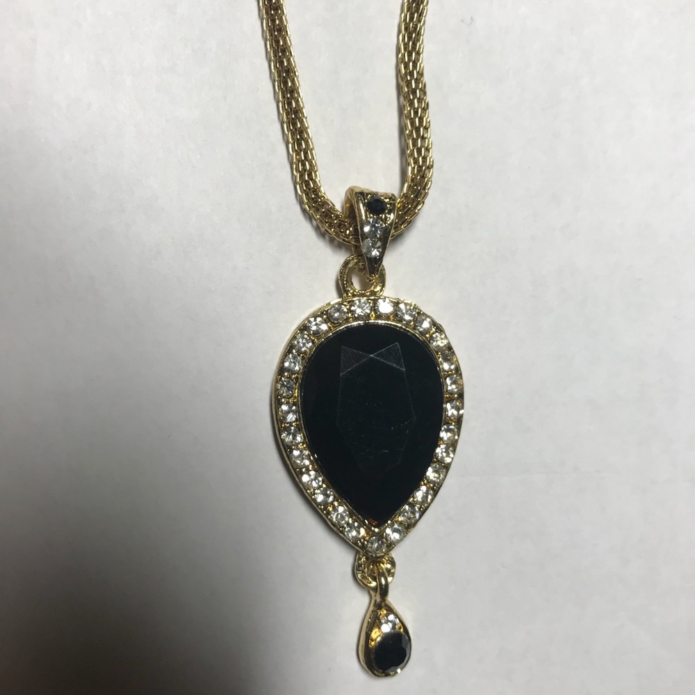 Black stone with silver stones and gold chain